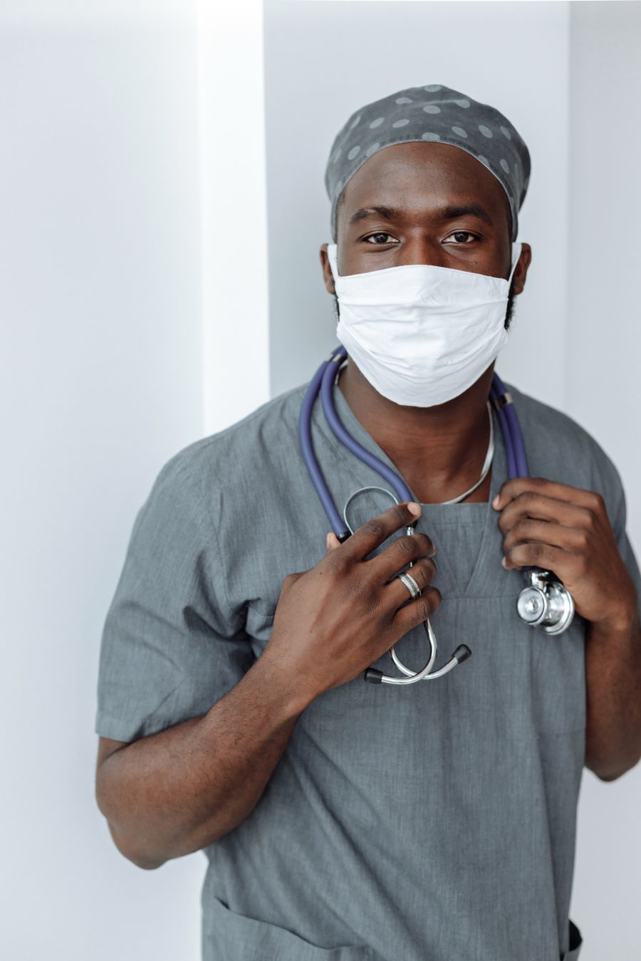 Malik Adeyemi in surgical scrubs