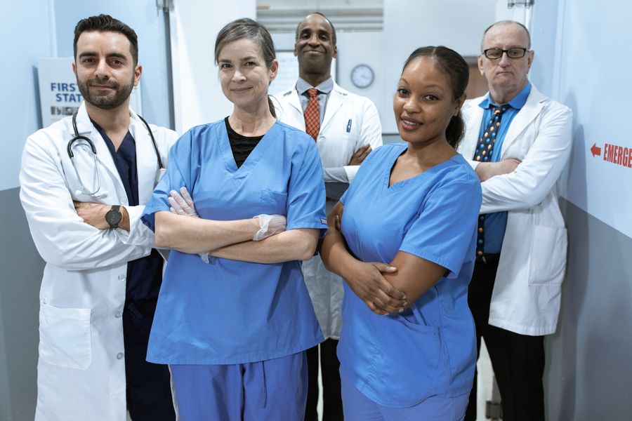 Nursing and medical colleagues together in a clinic corridor